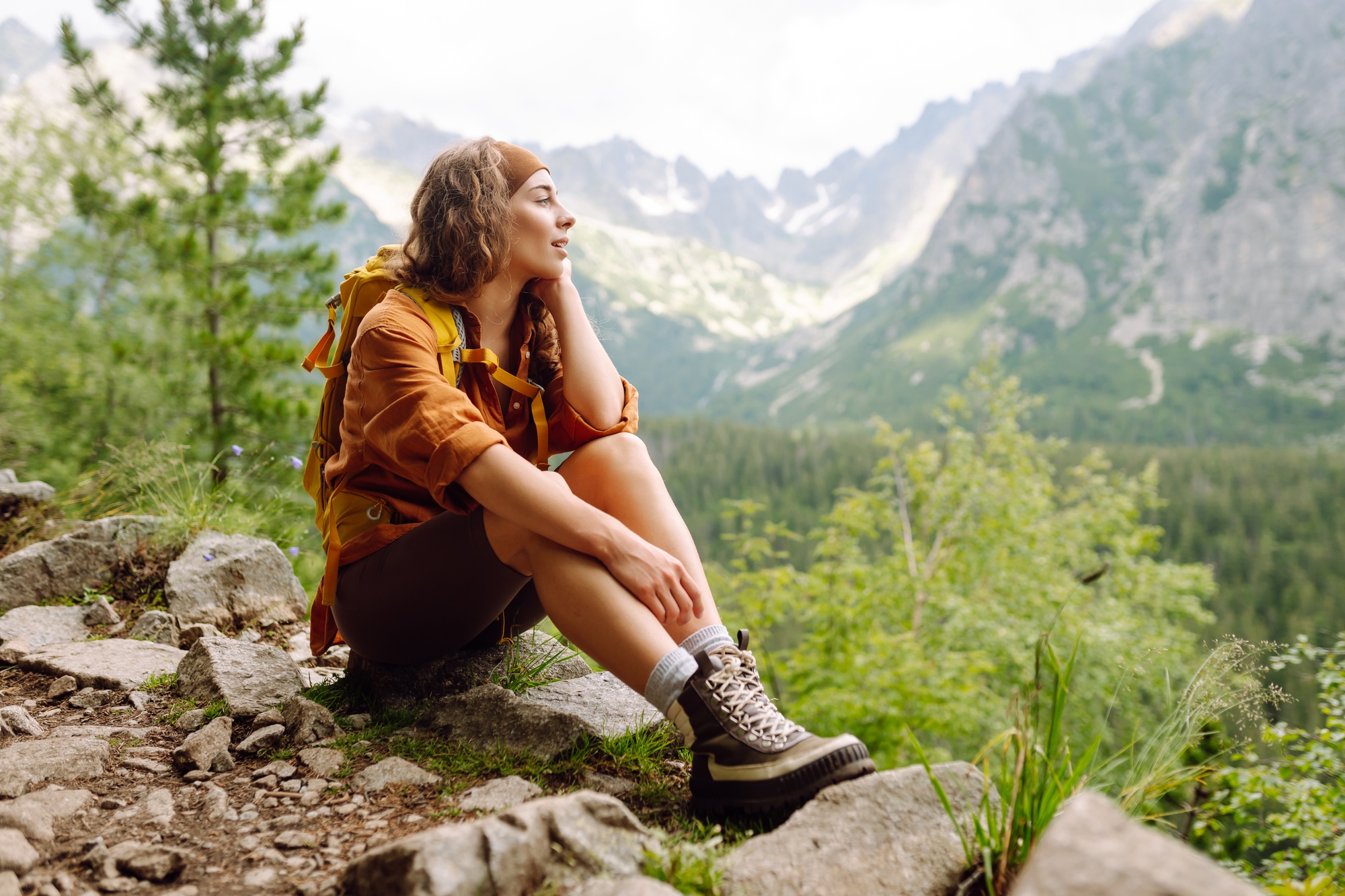 Close-up of female legs in hiking boots on a hiking trail. Travel, vacation. The concept of nature.